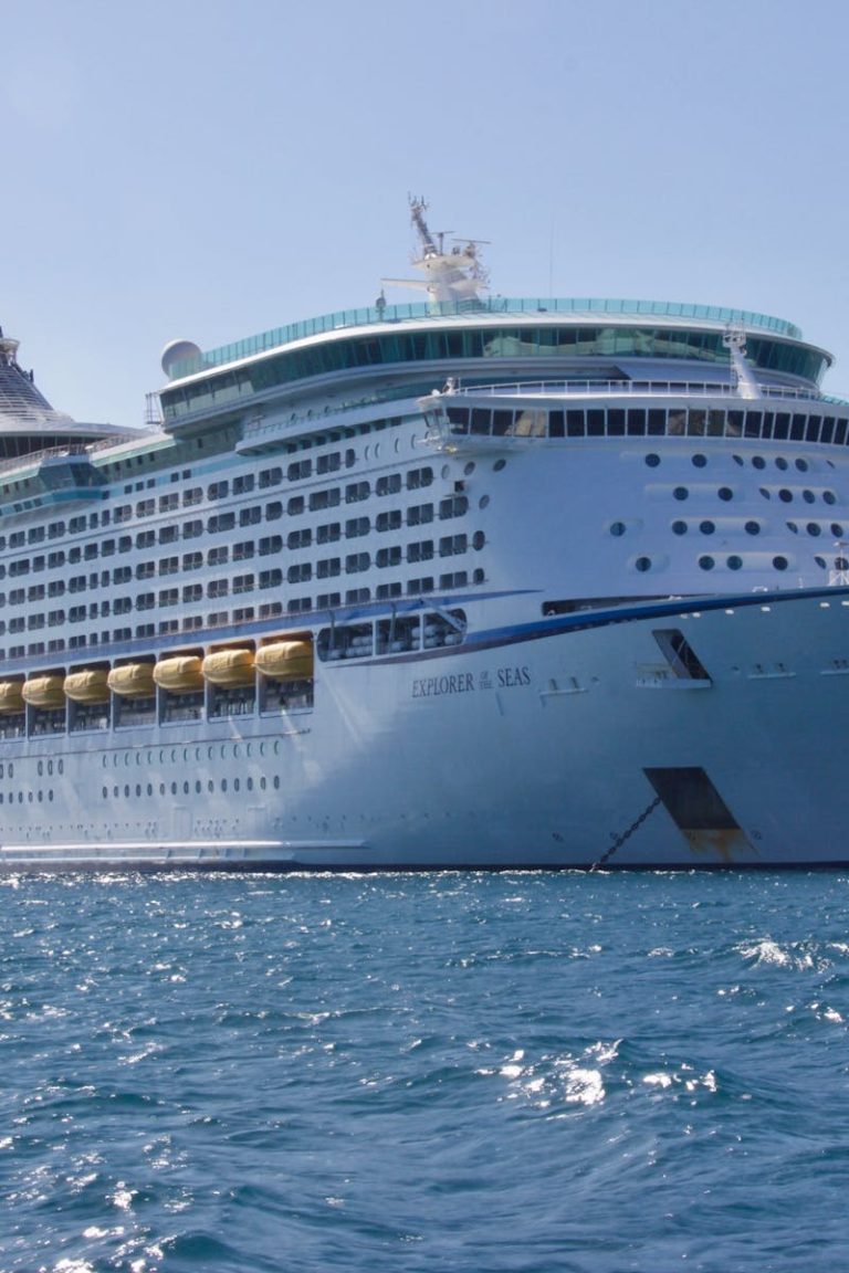 A luxurious cruise ship sailing on the ocean under a clear blue sky, ideal for travel and leisure.